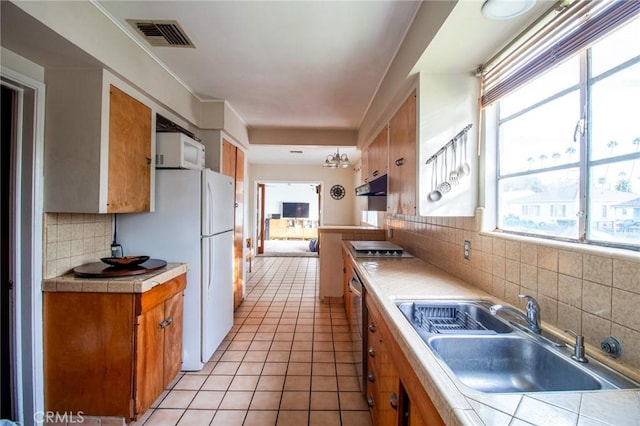 2484 Hanning Ave, Altadena, CA 91001 - kitchen featuring tile countertops, a sink, brown cabinets, and tasteful backsplash