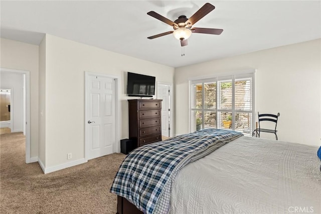 carpeted bedroom featuring baseboards and ceiling fan