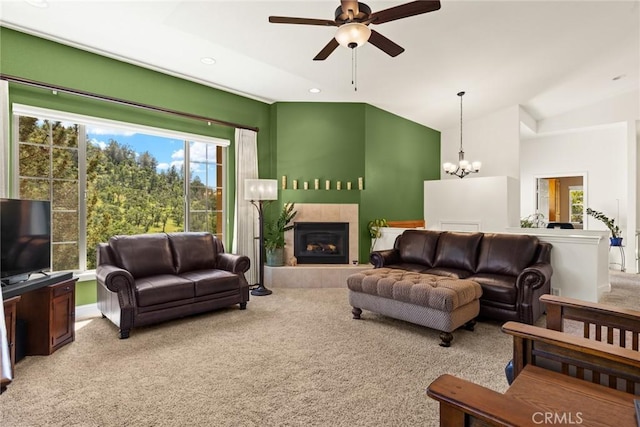 carpeted living area with baseboards, recessed lighting, a tile fireplace, ceiling fan with notable chandelier, and vaulted ceiling