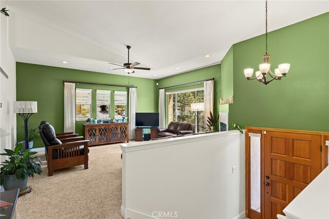 living room featuring recessed lighting, carpet, ceiling fan with notable chandelier, and vaulted ceiling
