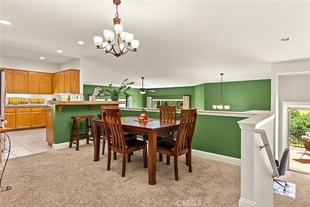dining space featuring light colored carpet, recessed lighting, light tile patterned floors, and a notable chandelier
