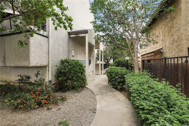 view of home's community featuring fence