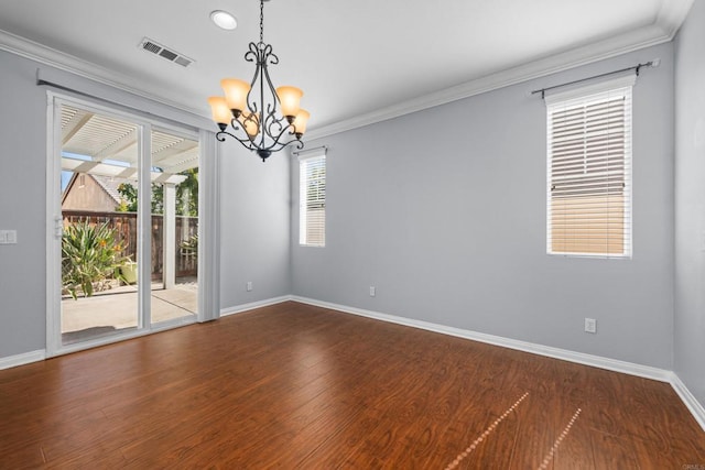 spare room featuring a chandelier, visible vents, crown molding, and baseboards