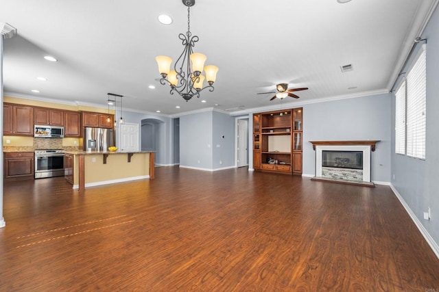 unfurnished living room with arched walkways, recessed lighting, a glass covered fireplace, and ceiling fan with notable chandelier