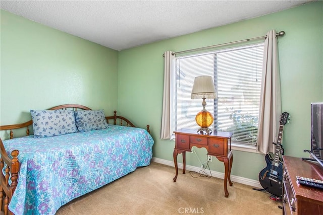 bedroom with baseboards, carpet flooring, and a textured ceiling