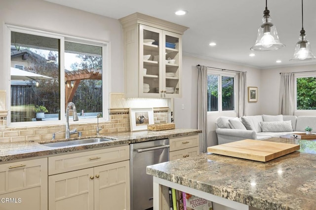 kitchen featuring light stone countertops, a sink, glass insert cabinets, tasteful backsplash, and stainless steel dishwasher