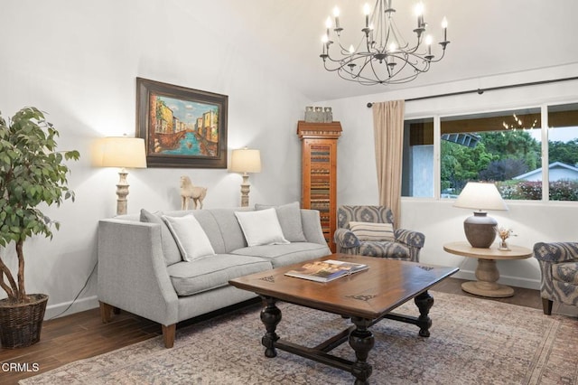 living area with baseboards, wood finished floors, an inviting chandelier, and lofted ceiling