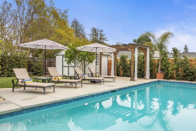 view of pool with a pergola, a patio area, an outdoor structure, a fenced in pool, and a fenced backyard