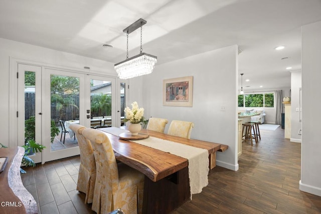 dining space featuring recessed lighting, an inviting chandelier, baseboards, french doors, and dark wood-style floors