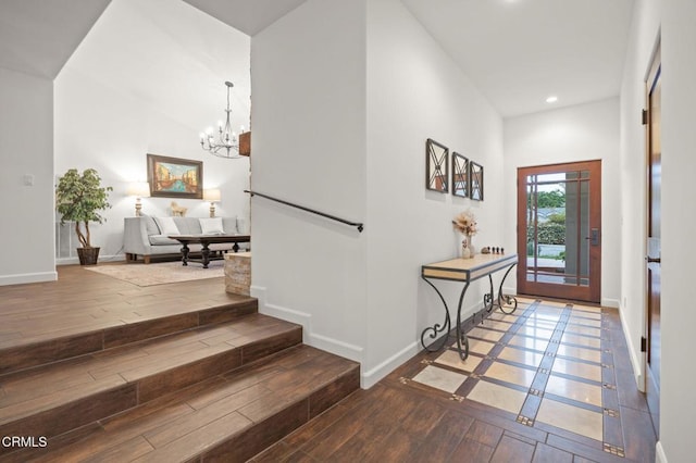 entryway with recessed lighting, an inviting chandelier, wood finished floors, and baseboards
