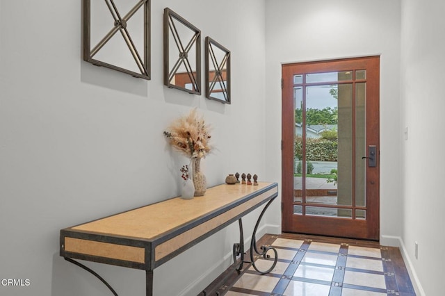 doorway to outside featuring baseboards