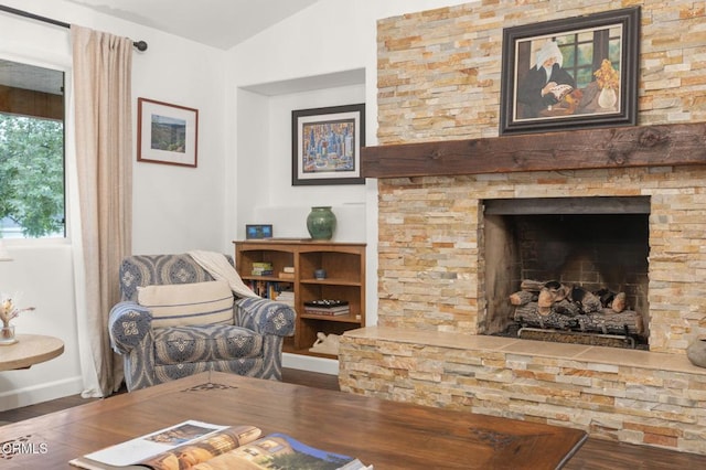 1109 Daly Rd, Ojai, CA 93023 - living room featuring wood finished floors, vaulted ceiling, a stone fireplace, and baseboards