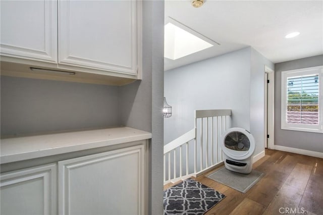 laundry area featuring hardwood / wood-style floors, baseboards, and recessed lighting