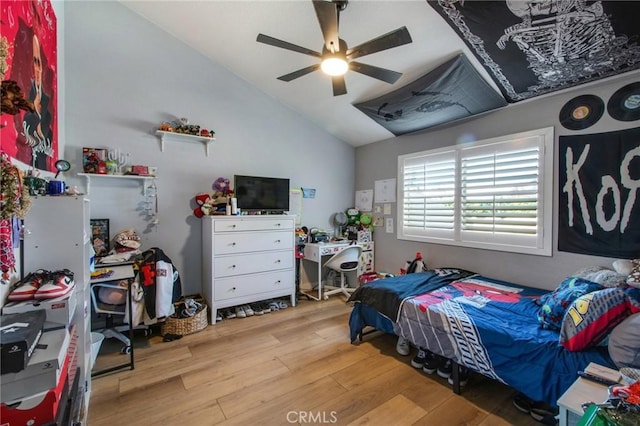 bedroom with vaulted ceiling, wood finished floors, and a ceiling fan