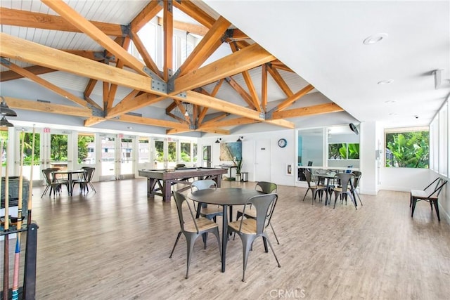 dining room with plenty of natural light, pool table, light wood-style flooring, and french doors