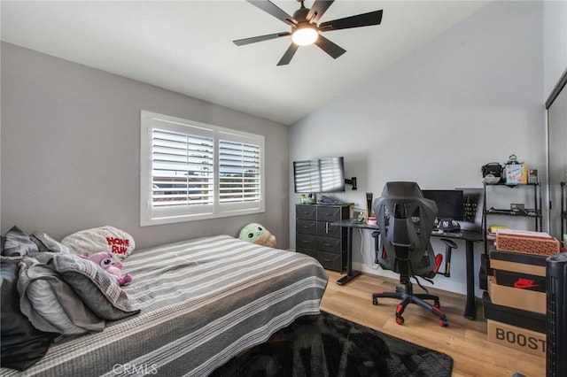 bedroom with vaulted ceiling, wood finished floors, and ceiling fan