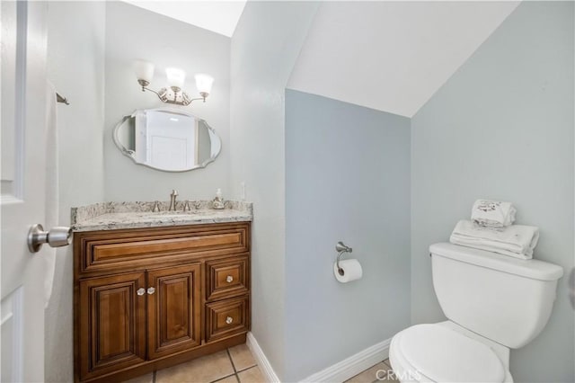 half bathroom featuring tile patterned floors, toilet, baseboards, lofted ceiling, and vanity