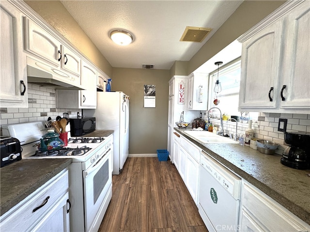 1120 S Yorktown St, Ridgecrest, CA 93555 - kitchen featuring white appliances, dark wood-style floors, backsplash, under cabinet range hood, and white cabinetry