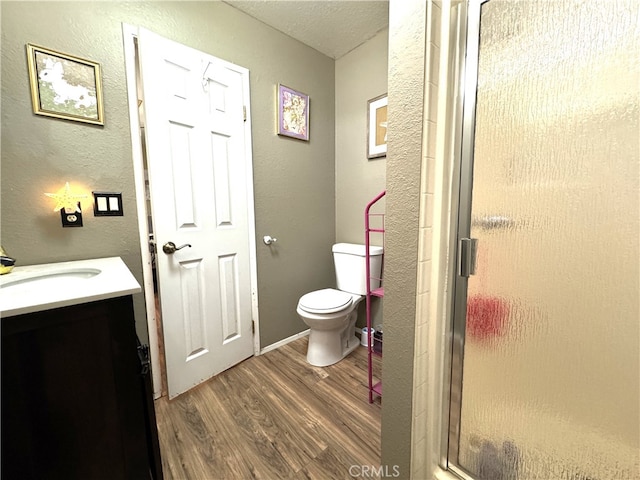1120 S Yorktown St, Ridgecrest, CA 93555 - full bath with wood finished floors, vanity, a stall shower, and a textured wall