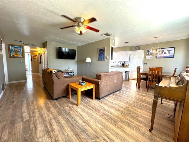 1120 S Yorktown St, Ridgecrest, CA 93555 - living area featuring a ceiling fan, light wood-style flooring, and a textured ceiling