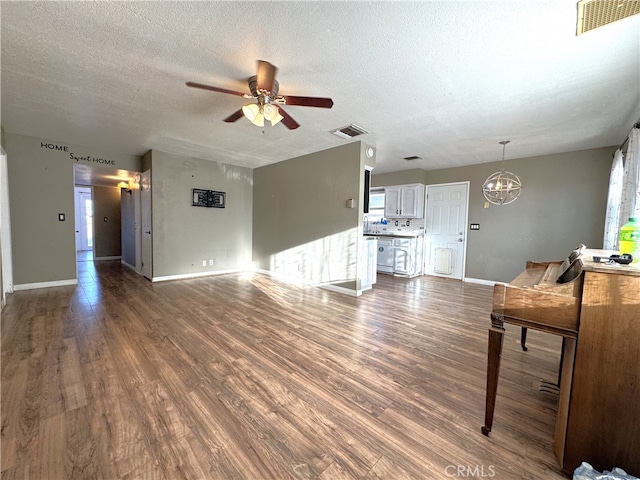 1120 S Yorktown St, Ridgecrest, CA 93555 - living room with ceiling fan, a chandelier, dark wood-style floors, and a textured ceiling