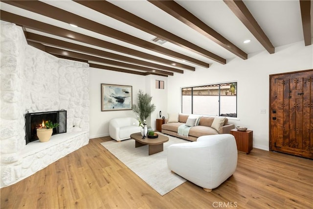 living room with wood finished floors, baseboards, beam ceiling, visible vents, and recessed lighting