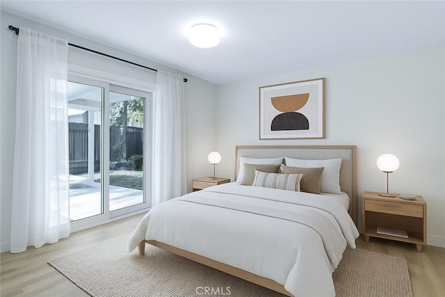 bedroom featuring light wood-style floors, access to exterior, and baseboards