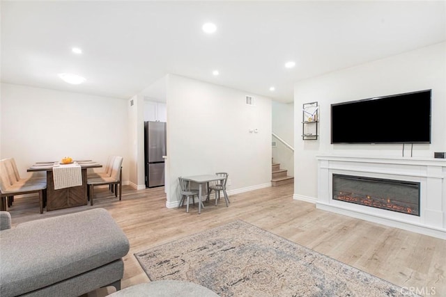 809 E Acacia Ave Unit H, Glendale, CA 91205 - living area featuring stairs, light wood finished floors, baseboards, visible vents, and recessed lighting
