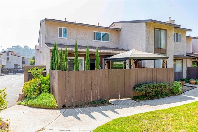 809 E Acacia Ave Unit H, Glendale, CA 91205 - townhome / multi-family property with fence, a chimney, a gazebo, and stucco siding