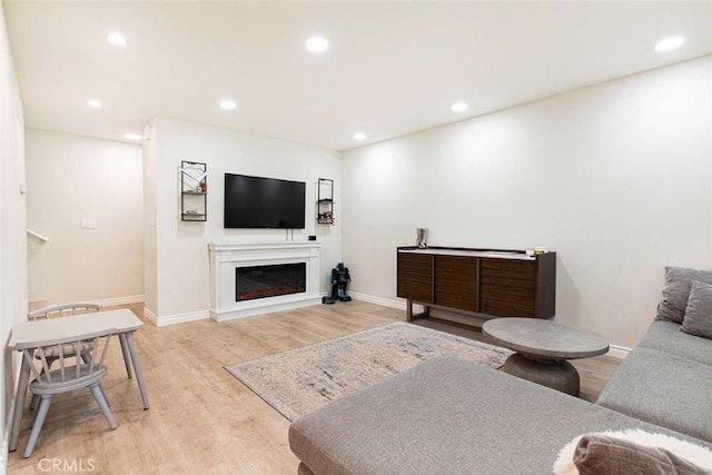 809 E Acacia Ave Unit H, Glendale, CA 91205 - living room with recessed lighting, baseboards, a glass covered fireplace, and light wood-type flooring