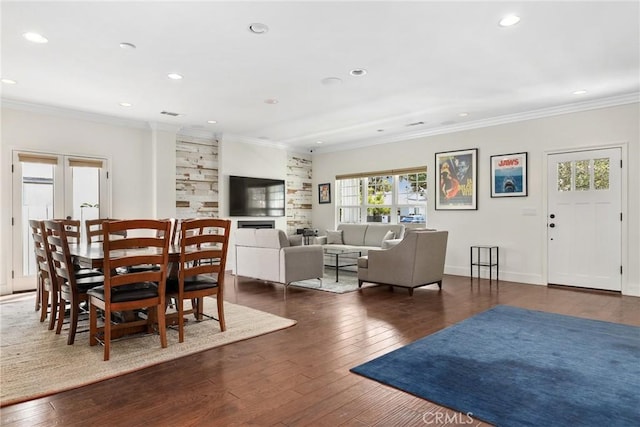 dining space featuring dark wood-type flooring, recessed lighting, crown molding, and baseboards