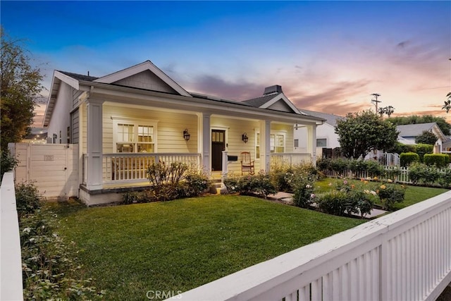 bungalow featuring a porch and a chimney