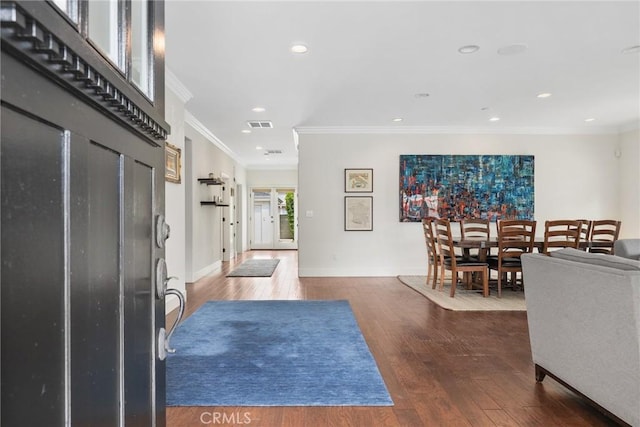 foyer entrance with crown molding, recessed lighting, wood finished floors, and baseboards