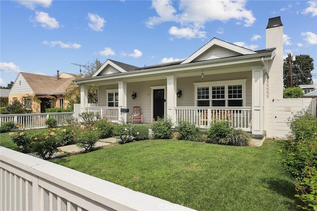view of front of home featuring covered porch and a chimney