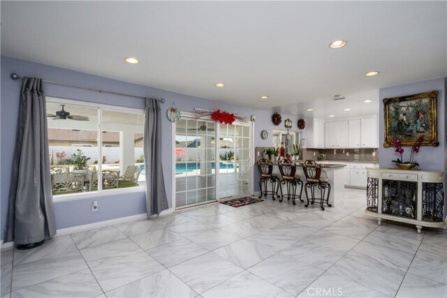 917 Brandywine Ln, Corona, CA 92880 - dining room with light marble finish flooring, recessed lighting, and baseboards