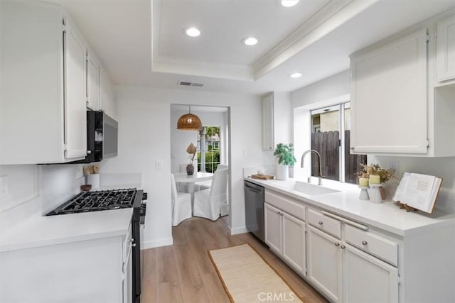 2720 E Walnut Ave Unit 10, Orange, CA 92867 - kitchen with appliances with stainless steel finishes, a sink, a raised ceiling, recessed lighting, and light wood finished floors