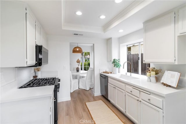 2720 E Walnut Ave Unit 10, Orange, CA 92867 - kitchen featuring gas range oven, dishwasher, a sink, a tray ceiling, and recessed lighting