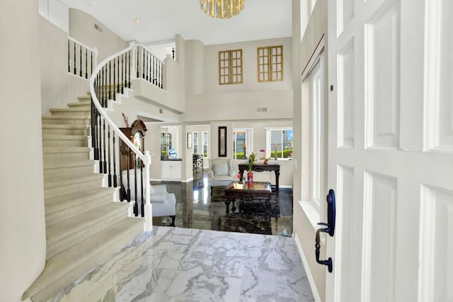 14082 Montfort Ct, San Diego, CA 92128 - foyer entrance with marble tiled floors, stairway, baseboards, a chandelier, and a high ceiling