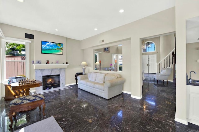 14082 Montfort Ct, San Diego, CA 92128 - living area featuring marble tiled floors, a fireplace, baseboards, stairs, and recessed lighting