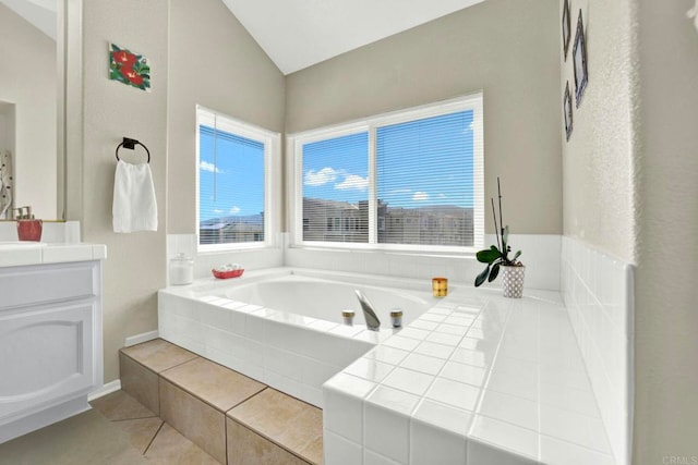 14082 Montfort Ct, San Diego, CA 92128 - bathroom featuring vaulted ceiling, a bath, vanity, and tile patterned flooring