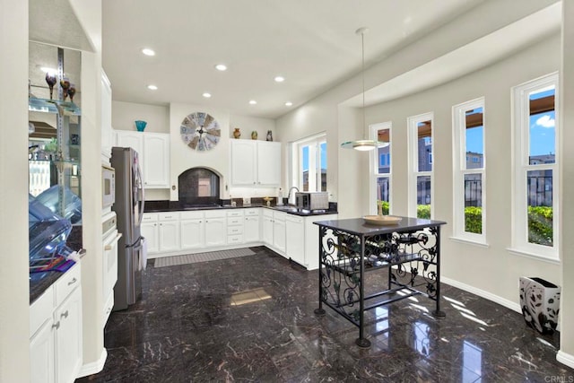 14082 Montfort Ct, San Diego, CA 92128 - kitchen featuring dark marble finish flooring, plenty of natural light, a sink, freestanding refrigerator, and recessed lighting
