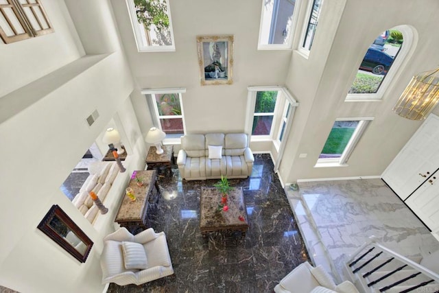 14082 Montfort Ct, San Diego, CA 92128 - living area featuring a towering ceiling, marble tiled floors, healthy amount of natural light, and baseboards