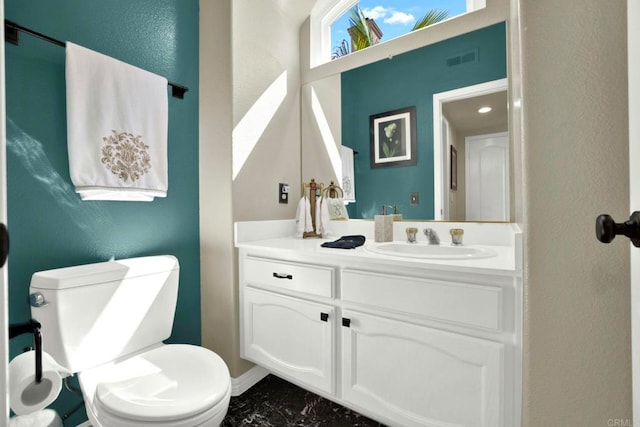 14082 Montfort Ct, San Diego, CA 92128 - bathroom with marble look tile flooring, toilet, vanity, and a textured wall