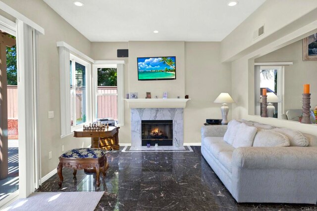 14082 Montfort Ct, San Diego, CA 92128 - living area with plenty of natural light, a high end fireplace, marble tiled flooring, and recessed lighting