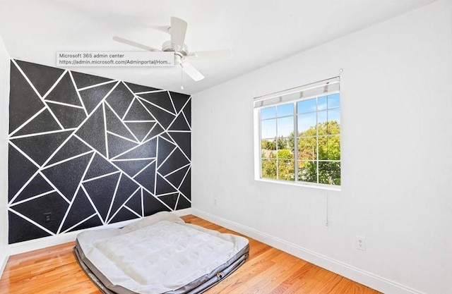 unfurnished bedroom featuring baseboards and wood finished floors