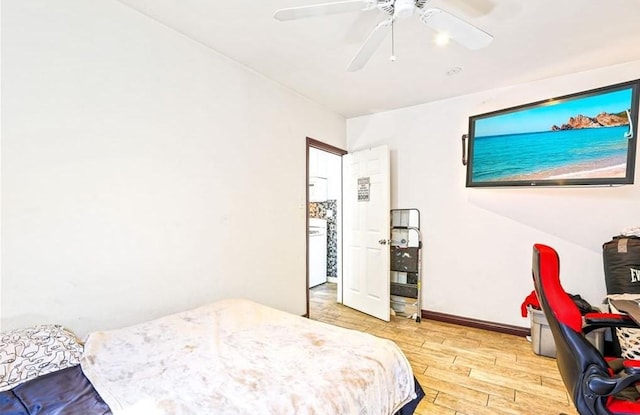 bedroom with ceiling fan, baseboards, and light wood-type flooring