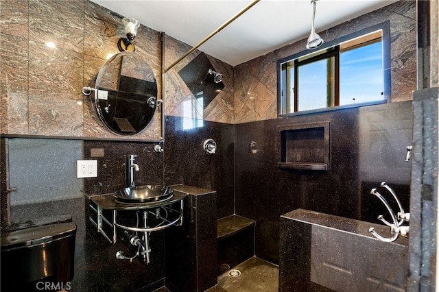 bathroom featuring two vanities, a sink, and a shower
