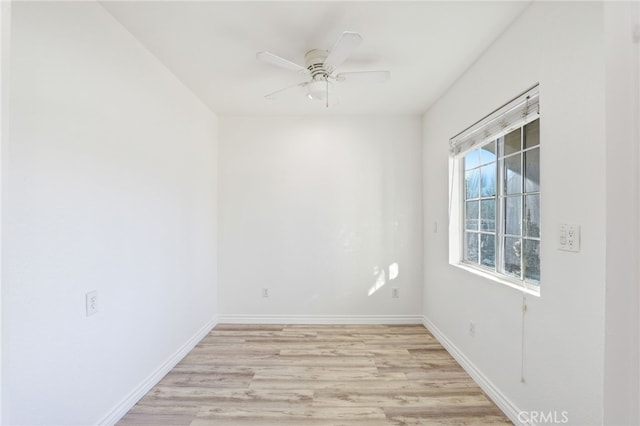 empty room featuring light wood-style flooring, baseboards, and a ceiling fan