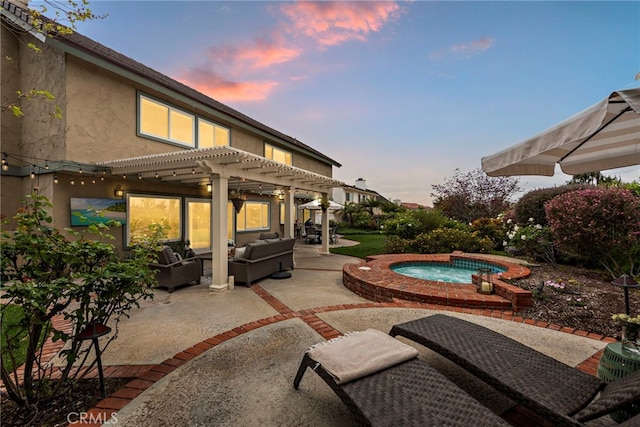 view of patio / terrace featuring a pergola, outdoor lounge area, and an in ground hot tub