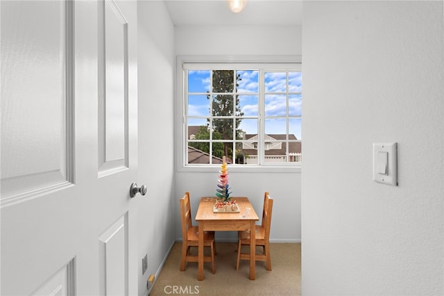 dining space with baseboards and carpet floors